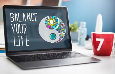 Laptop displaying a yin yang logo, symbolising the concept of work-life balance.