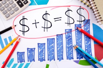 Image of a dollar sign on paper alongside pencils and a calculator, illustrating part-time staff employment costs.
