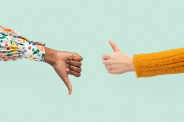 Two people giving thumbs up and down on a green background, symbolising the importance of hiring the right candidates.