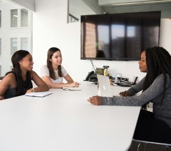 A meeting room scene with a diverse group of individuals