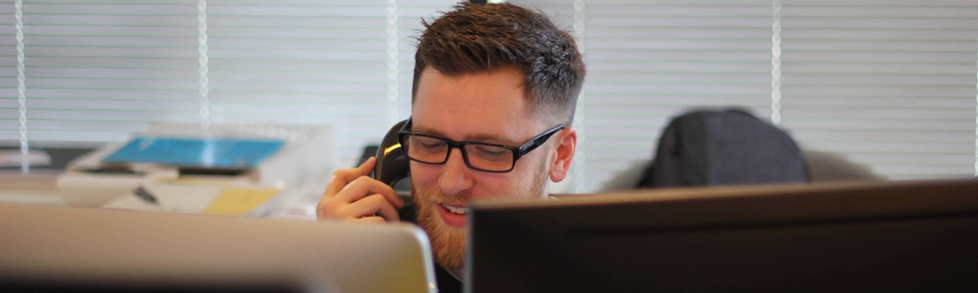 A Part Qualified finance professional speaks to an accountancy colleague on the phone