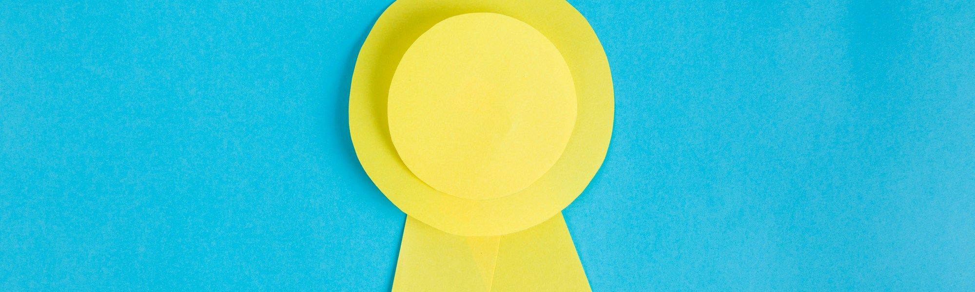 A yellow ribbon gracefully adorns a serene blue background, creating a harmonious contrast.