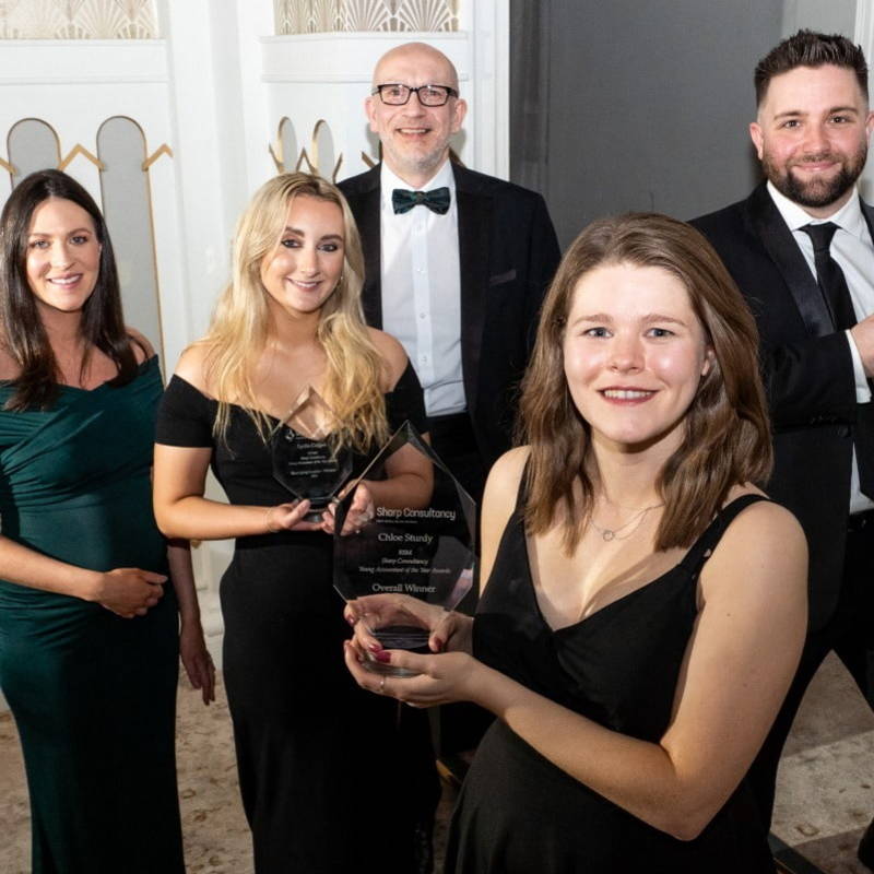 An image capturing the moment at the Queens Hotel in Leeds, showcasing the accomplished winner and finalists of Sharp Consultancy's Young Accountant of the Year 2023 Awards.